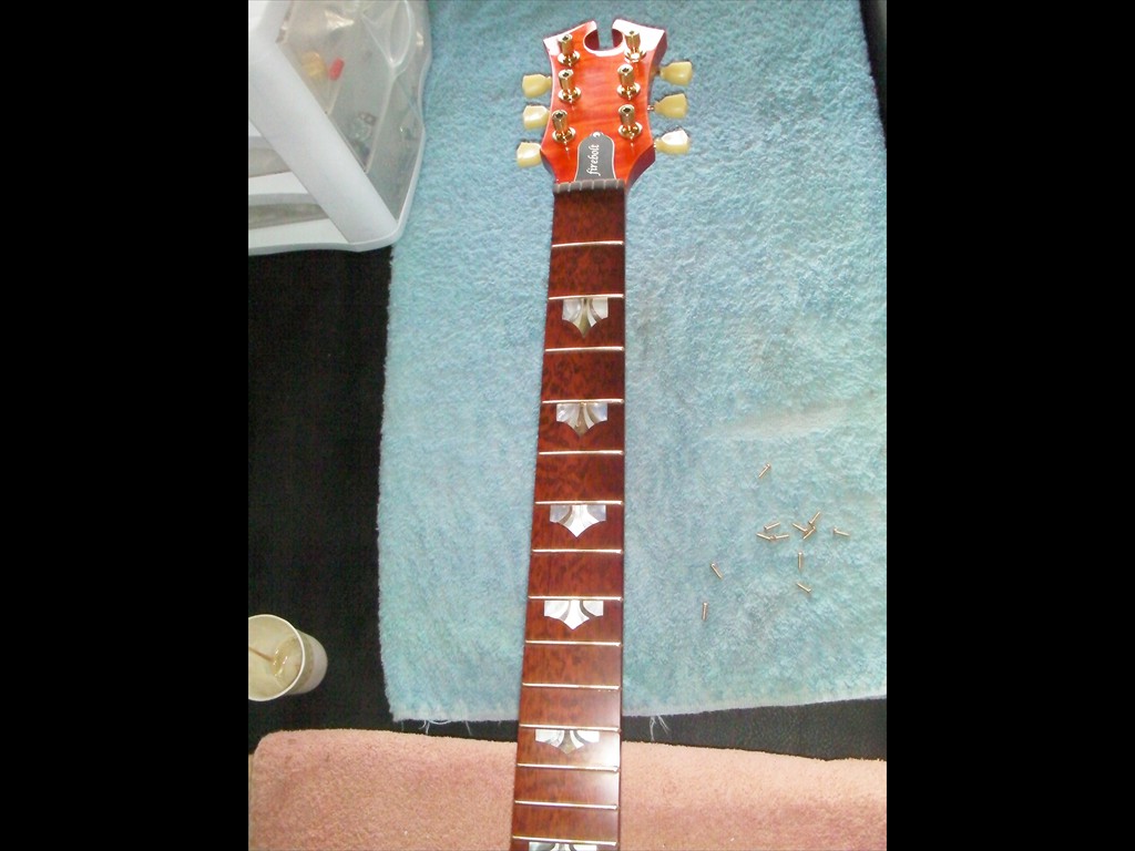 Firebolt in Tangerine Flame Maple with White MOP Purfling and Snakewood Fretboard